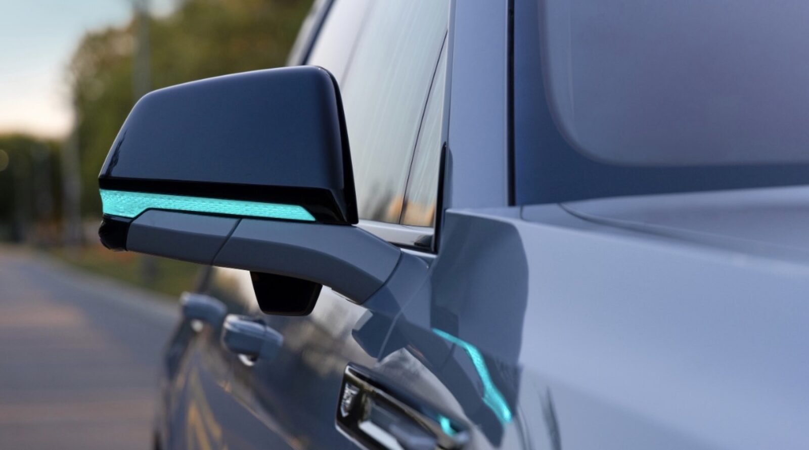 The turquoise lighting across the dashboard and mirrors indicates the vehicle is operating autonomously. Photo courtesy of GM.